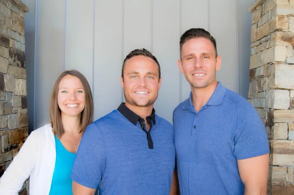 Practitioners at the stacked stone entrance of Maynard Family Chiropractic in Broken Arrow, OK